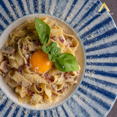 Creamy tagliatelle carbonara at Danial’s Cuisine, Kestel — topped with egg yolk, basil and parmesan
